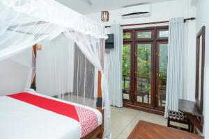 a bedroom with a bunk bed and a balcony at French Garden Kandy in Kandy