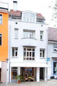 a white building with a white awning at Business Apartment in Markdorf
