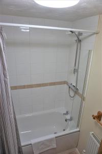 a bathroom with a shower and a bath tub at Palmer's Apartment in Bristol