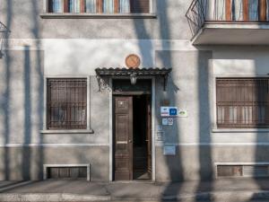 a door to a building with a sign above it at Il Broletto B&B in Novara