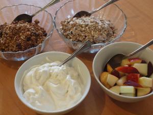 four bowls of food with fruit and whipped cream at Herriot's in Hawes