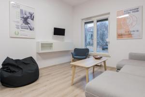 a living room with a couch and a table at Dom gościnny Luk Luk in Sopot