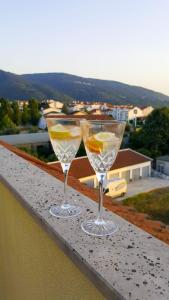 two wine glasses sitting on top of a ledge at Casa Bruins in Lousã