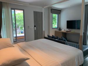 Ein Bett oder Betten in einem Zimmer der Unterkunft Bann Pantai Resort
