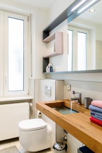 a bathroom with a white toilet and a sink at Lago Welcome Place d'Armes I in Luxembourg