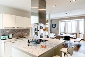 a kitchen with white cabinets and a counter top at Lago Welcome Place d'Armes I in Luxembourg
