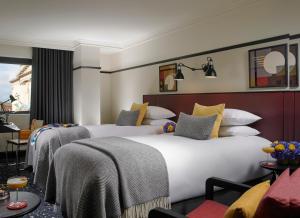 a hotel room with two beds and a couch at The Mont in Dublin