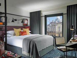 a bedroom with a large bed and a large window at The Mont in Dublin