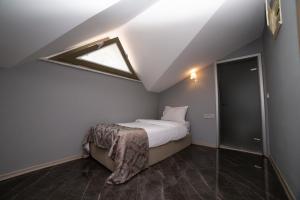 
a bedroom with a bed and a window at HHK Hotel Downtown in Istanbul
