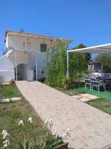 a external view of a house with a patio at Angel House in Drosia