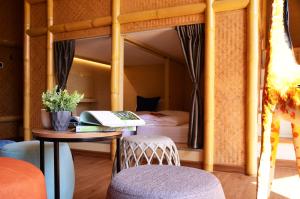 a bedroom with a bunk bed with a desk and a table at Pannana Cha-am in Cha Am