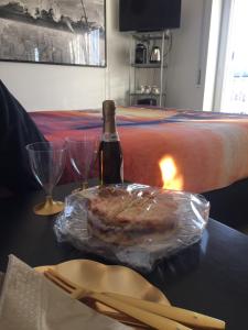a bottle of wine and a piece of food on a table at Alloggio Turistico Roberta San Pietro in Rome