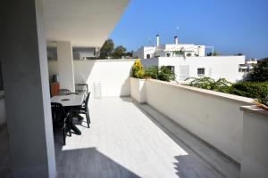 a balcony with a table and chairs on a building at Rodeo Apartments in Marbella