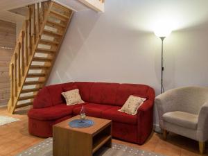 sala de estar con sofá rojo y mesa en Holiday Home Karitahko a 2 by Interhome en Tahkovuori