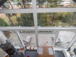 a view from the loft of a house with a large window at Holiday Home Sjöboda by Interhome in Inkoo