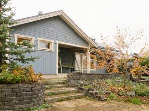 a house with a retaining wall and stairs in front of it at Holiday Home Villa lehmus by Interhome in Rovaniemi