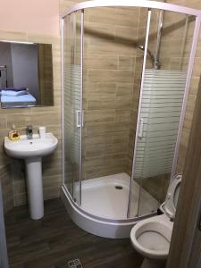 a bathroom with a shower and a toilet and a sink at #8 Apartments in Odesa