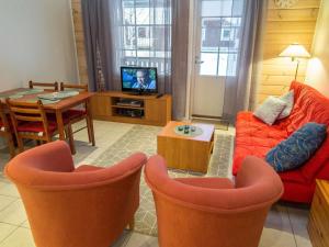 a living room with a couch and a table at Holiday Home Karitahko a 7 by Interhome in Tahkovuori