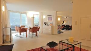 a living room with a table and a dining room at Villa Abetaia With Pool in Tremosine Sul Garda