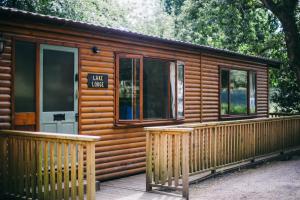 a wooden cabin with a porch and a door at Chycara in Truro