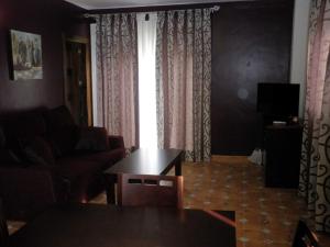 a living room with a couch and a table at Alcaidia De Magina in Cambil +10 photos