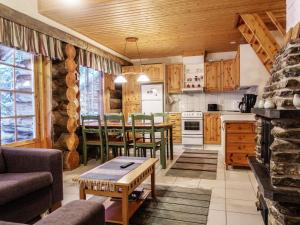 a kitchen and living room with a table and chairs at Holiday Home Kiiruna by Interhome in Sirkka