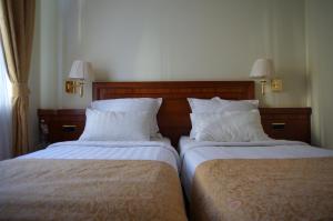 Postel nebo postele na pokoji v ubytování My City Hotel