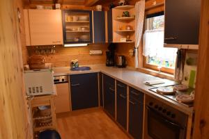 a kitchen with wooden cabinets and a counter top at MaRei-Hütte in Hohentauern