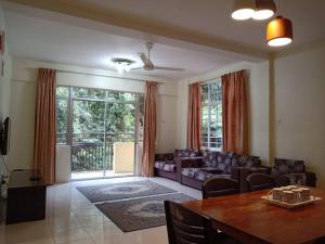 a living room with a couch and a table at Mag Homestay at Crown Imperial Court, Brinchang in Cameron Highlands