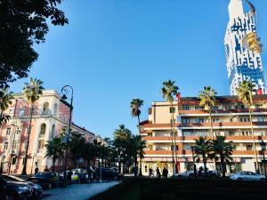 a city street with palm trees and a large building at Keti 's Apartment in Batumi in Batumi