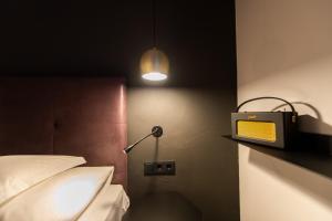Postel nebo postele na pokoji v ubytování Burgus - Design Suites & Apartments