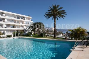 a large swimming pool in front of a building at Acapulco playa Nerja 407 planta superior in Nerja