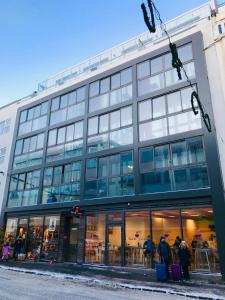 een groot gebouw met mensen die er buiten staan bij City Center Luxury Apartment in Reykjavík