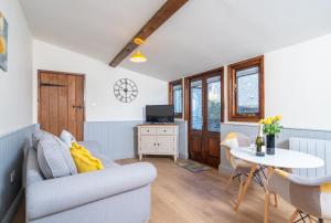 a living room with a couch and a table at The Brewery lodge in Cirencester