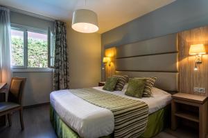 Postel nebo postele na pokoji v ubytování Hôtel Mireille