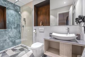 a bathroom with a sink and a toilet and a shower at Casa SEDRA in Braşov +29 photos