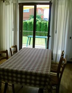 a table with a checkered table cloth on it in front of a window at Villa Berta in Riva del Garda