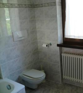 a bathroom with a toilet and a sink at Villa Berta in Riva del Garda