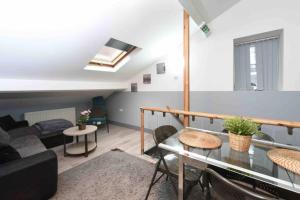 a living room with a couch and a table at Back Turner Townhouse in Manchester