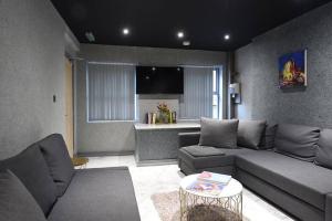 a living room with a couch and a table at Back Turner Townhouse in Manchester