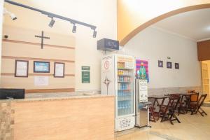 a refrigerator in a room with a restaurant at Pousada Santa Cruz in Aparecida