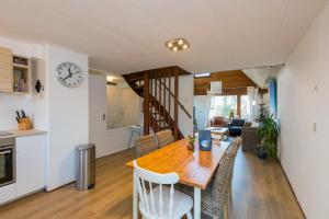 a kitchen and dining room with a table and chairs at Kievitenlaan 22 in Veere