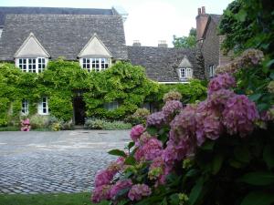 een huis met roze bloemen ervoor bij Wadham College in Oxford