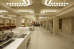 a large room with a buffetasteryasteryasteryasteryasteryasteryasteryasteryasteryastery at Artilla Inn in Ahmedabad