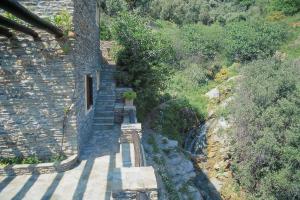 an aerial view of a stone building and a river at Anastasia Luxury Villas in Gavrio