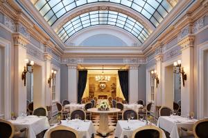 a dining room with tables and chairs and a skylight at The Jefferson Hotel in Washington, D.C.