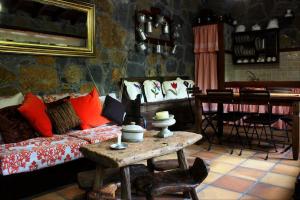 a living room with a bed and a table with a table at CASA MARY LOLA in Tiñor
