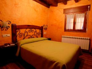 a bedroom with a large bed in a room at La Casona del Herrero in Navaleno