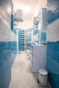 a blue and white bathroom with a toilet and a sink at New In!Amalie at Santa Lucia in Naples