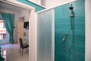 a bathroom with a shower with a glass door at New In!Amalie at Santa Lucia in Naples
